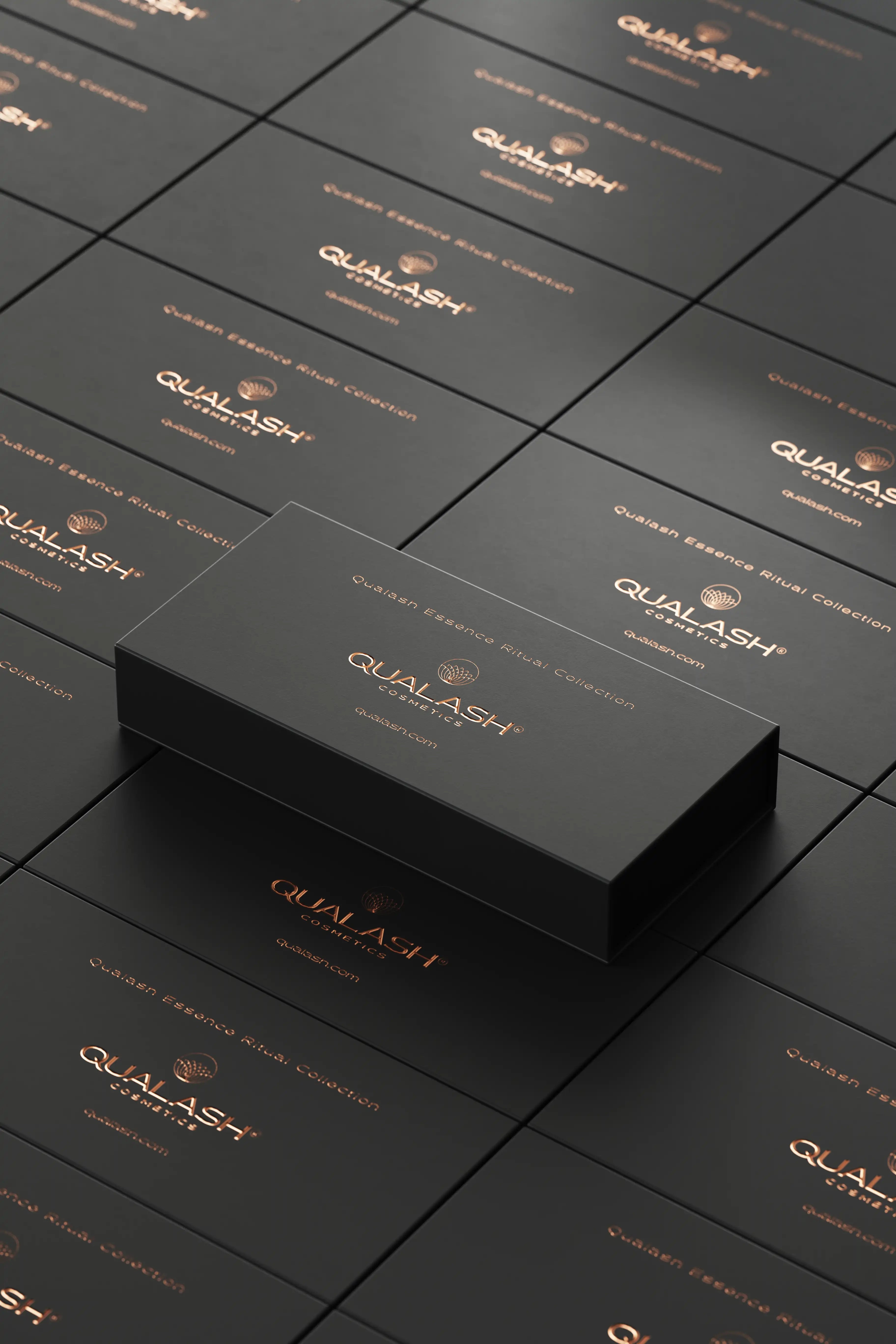 Stacked black QUALASH Collection boxes with copper logo – high-end product presentation.